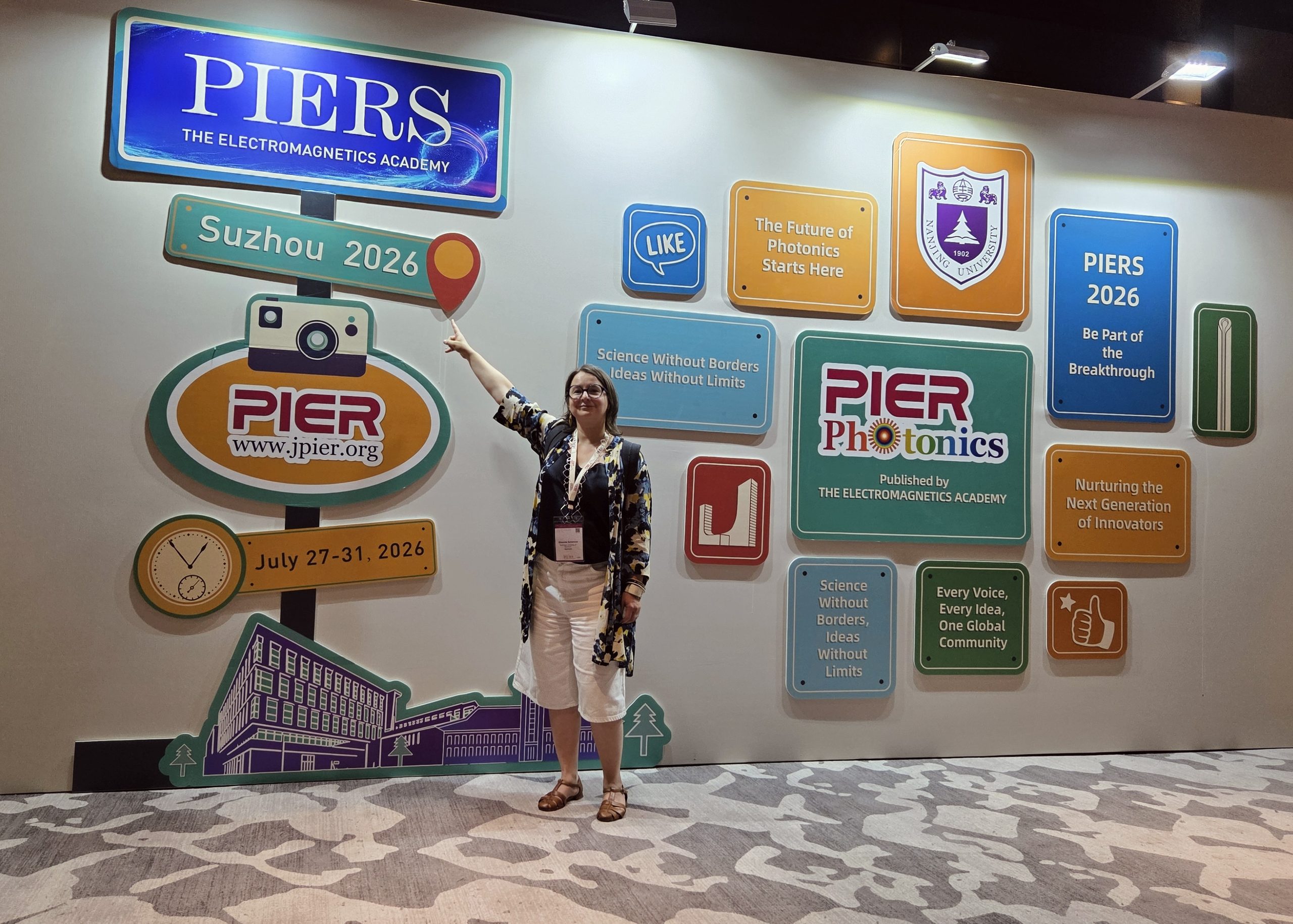 Prof. Semenova pointing to a directional sign for the conference in Suzhou.